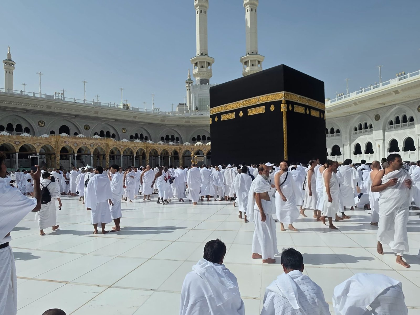 Pilgrims in ihram near the Kaaba
